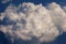 Aerial view from the airplane window to a fluffy cloud