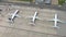 Aerial view of airplanes waiting on airport parking lot in front of modern airport in Wroclaw. Orbital shot and tilt down view