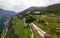 Aerial view of the alpine vineyards on a summer day. flat rows of fields, farms, small village of Faver, famous for wine