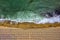 Aerial view of an amazing beach with white umbrellas, lounge chair, and turquoise sea.