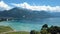 Aerial view of amazing city seashore near the clear seawater, yachts and large old mountains on the background against