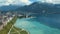 Aerial view of amazing city seashore near the clear seawater, yachts and large old mountains on the background against