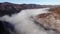 Aerial view of amazing landscape of Carpathian Mountains. Morning fog spreads over the river and envelopes the mountains and fores