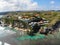 Aerial view of an amazing little surfer village on the rock cliff and coastline.