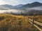 Aerial view amazing over of the Carpathian Mountains or Carpathians with Beautiful autumn landscape , sunrise, blue sky with white