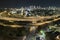 Aerial view of american freeway intersection at night with fast driving cars and trucks in Miami, Florida. View from