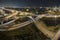 Aerial view of american freeway intersection at night with fast driving cars and trucks in Miami, Florida. View from