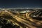 Aerial view of american freeway intersection at night with fast driving cars and trucks in Miami, Florida. View from