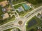 Aerial view of american suburban area with rural road roundabout intersection with moving cars traffic. Circular