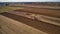 Aerial View of Amish Farm Worker Turning the Field in Early Spring as Seen by a Drone