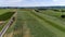 Aerial View of Amish Farmlands with Corn Growing and Harvesting Alfalfa, by a Single Railroad Track