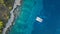 Aerial view of anchoring catamaran next to island.