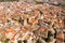 Aerial view of ancient quarter of Caceres with brownish tiled roofs