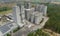 Aerial view of animal feed factory. Agricultural silos, grain storage silos, and solar panel on roofs of industrial plants.