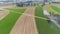 Aerial view of an antique restored steam engine traveling thru farmlands blowing smoke and steam