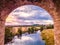 Aerial view through an arch of Arthington Viaduct upriver on River Wharfe