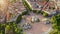 Aerial view of Arco della pace Milano Lombardia imperial monument in center drone flight shot over city round square in