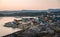 Aerial View of Arctic city of Ilulissat, Greenland during sunrise sunset. Colorful houses in the center of the town with