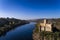 Aerial view of the Armourol Castle with a boat passing in the Tagus River in Portugal