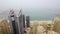 Aerial view of the array of skyscrapers facing the sea in the small fog. Dubai, United Arab Emirates