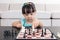 Aerial view of Asian Chinese little girl concentrating on chess