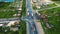 Aerial view of an asphalt suburban intersection with moving cars.