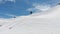 Aerial view athlete skier freerider stands atop the sidelines high in the mountains preparing to descend down. Skitour