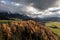 Aerial view of an autumn forest on the background of mesmerizing rocky mountains