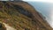 Aerial view of autumnal forest, rocky shore with cliff and sea