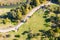 Aerial view of autumnal park landscape with footpath and yellow trees