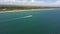 Aerial view of the beach along the coastline. The drone flies forward