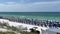 An aerial view of the Beach with Blue Umbrella and Lounge Chairs lined up at the Watercolor Community Club in Watercolor, Florida