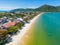 Aerial view of beach with boats, houses and forest