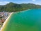 Aerial view of beach with boats, houses and forest