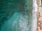 Aerial view of a beach with canoes, boats and umbrellas