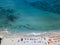 Aerial view of a beach with canoes, boats and umbrellas