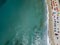 Aerial view of a beach with canoes, boats and umbrellas