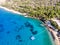 Aerial View of Beach Cove with Sunbeds, Blue Turquoise Sea and Trees.