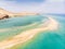 Aerial view of beach in Fuerteventura island with windsurfers learning windsurfing in blue turquoise water during summer vacation