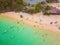 Aerial view of beach at Koh Khai, a small island, with crowd of people, tourists, blue turquoise seawater with Andaman sea in