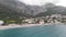 Aerial view of the beach near Bar, Montenegro. Drone sight of a small seaside town with mountains and waves in the sand