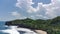 aerial view of beach near green cliff with beautiful waves