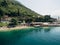 Aerial view of the beach of Perast city with various buildings and green mountains in the background