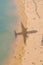 Aerial View of beach with shadow of airplane