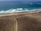 Aerial view of a beach, shore, waves crashing on the coast. Famara Beach, Lanzarote, Canary Islands, Spain