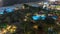 Aerial view of beach and tourists walking in JBR with skyscrapers night timelapse in Dubai, UAE