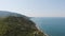 Aerial view of beach, a tropical forest and ocean with waves. Azure beach with rocky mountains and clear water.