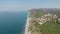 Aerial view of beach, a tropical forest and ocean with waves. Azure beach with rocky mountains and clear water.