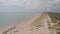 Aerial view of beach, a tropical forest and ocean with waves. Azure beach with rocky mountains and clear water.