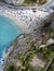 Aerial view of a beach with umbrellas and bathers. Tropea, Calabria, Italy